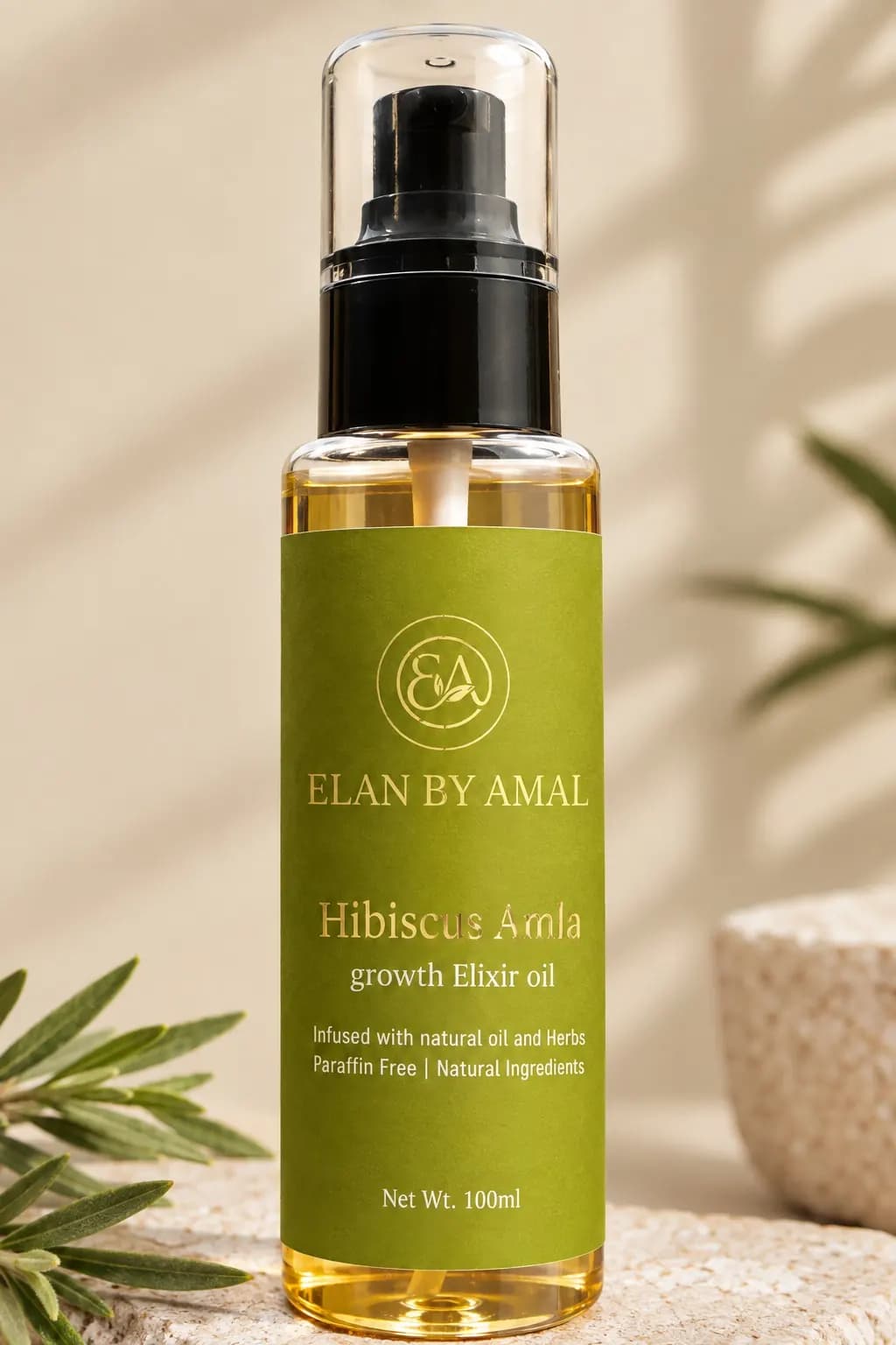 Close-up of the gold foil Elan by Amal label and olive leaves